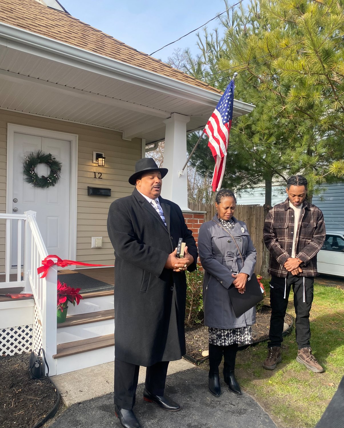 Bishop Harrison Hale, the senior pastor of Cornerstone Church of God in Christ Inc., blesses DeVon and Helen’s new home in Bay Shore.